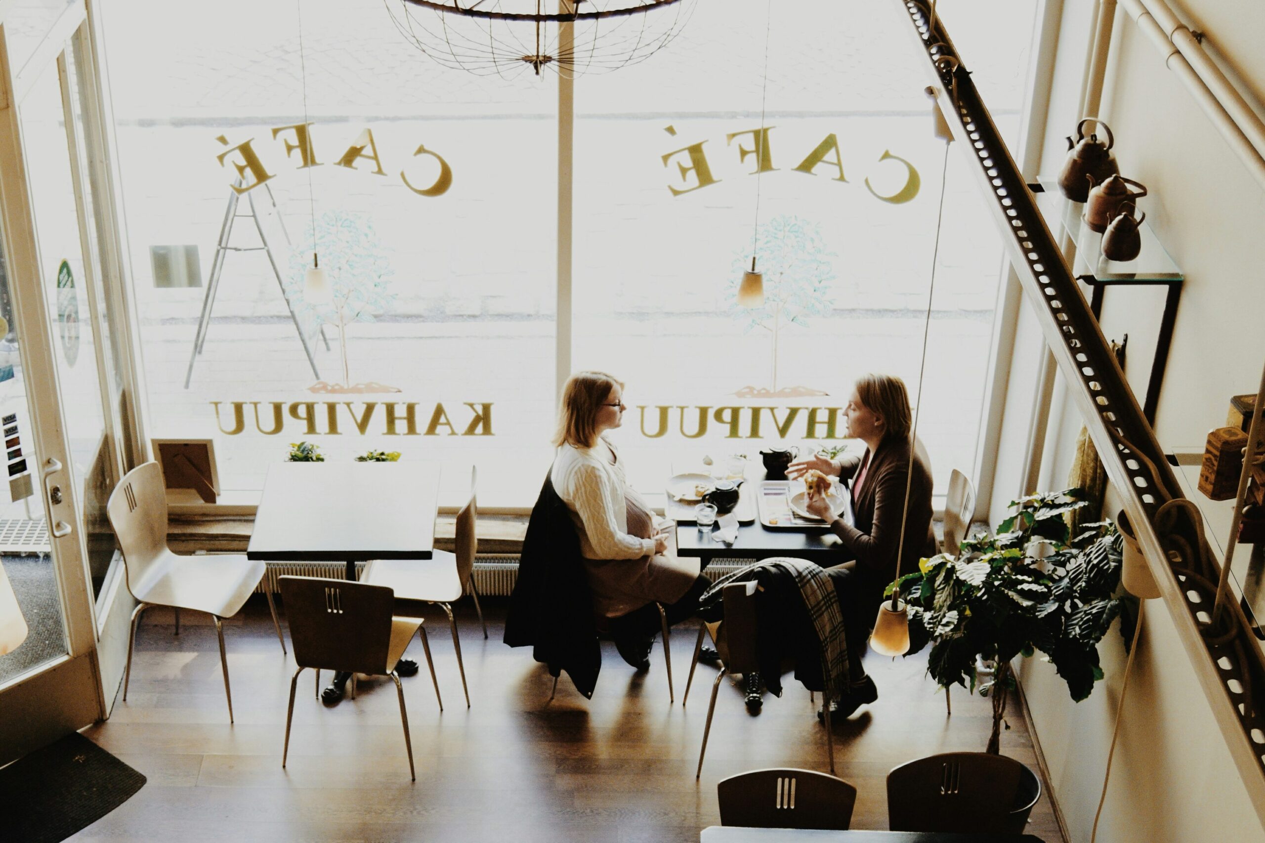 Business Women Consulting Over Coffee